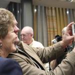 Patty Lent takes a photo with a Bremerton resident at her farewell party Dec. 28.                                Michelle Beahm / Kitsap News Group