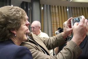 Patty Lent takes a photo with a Bremerton resident at her farewell party Dec. 28.                                Michelle Beahm / Kitsap News Group