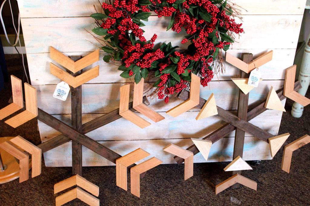 Danielle Gilchrist and her husband created wooden snowflakes to sell in Gigis Emporium PNW.                                <em>(Michelle Beahm | Kitsap Daily News)</em>