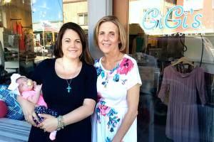 Danielle Gilchrist, left, with her daughter Aeva and mother Marie Carins in front of Gigis Emporium PNW. Together they own Gigis Emporium and manage both locations on opposite sides of the country.<em> (Courtesy photo)</em>