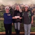 Charol Riedel and Debra Davies of the Port Orchard Eagles Club presented a check of $3,500 to Jennifer Hardison of Helpline (center) to help the organization feed hungry community members and provide Christmas gifts for needy children. (Courtesy photo)