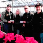 Members of the Saints Car Club of Port Orchard donated financial contributions and in-kind volunteer assistance to the South Kitsap Helpline. Shown left to right: Mark Fessenden, club president; Jennifer Hardison, Helpline executive director; Jerry Newland, membership chairman; and Rich Rueter, club members. (Courtesy photo)