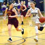 Raelee Moore (23) of North Kitsap on the fast break as Kingstons Lily Beaulieu (12) attempts to stop her. (Mark Krulish/Kitsap News Group)