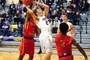 <em>Logan Chmielewski of North Kitsap goes up for a shot against Jai Poole (1) and Alex Bing (2) of Franklin Pierce in the teams 71-43 victory on Jan. 6.  </em>Mark Krulish/Kitsap News Group