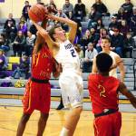 <em>Logan Chmielewski of North Kitsap goes up for a shot against Jai Poole (1) and Alex Bing (2) of Franklin Pierce in the teams 71-43 victory on Jan. 6.  </em>Mark Krulish/Kitsap News Group