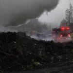 North Kitsap Fire & Rescue firefighters had contained a stump pile fire near Hansville around noon, but reported that the fire was stubborn, so firefighters would likely be on scene throughout the day.                                NKF&R/Courtesy