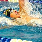 Kingstons Quincy Walker swims to victory in the 100 backstroke with a time of 56.02 against Olympic. (Mark Krulish/Kitsap News Group)