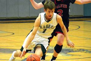 <em>Klahowyas Jacob Kraft (1) slips by a Coupeville defender. His team picked up an important 51-37 win over the Wolves on Jan. 16.</em> Mark Krulish/Kitsap News Group
