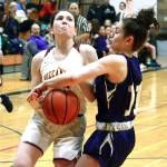 Kingstons Lily Beaulieu fights through the defense of North Kitsaps Lauren Weins (11). Beaulieu led her team with 21 points. (Mark Krulish/Kitsap News Group)