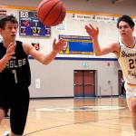 Klahowyas Jacob Kraft (1) and Bremertons Gavin King (21) scramble for a loose ball. The Knights won their first game of the season on Jan. 26, defeating the Eagles 58-43. (Jacob Moore/Kitsap News Group)
