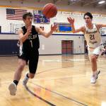 Klahowyas Jacob Kraft (1) and Bremertons Gavin King (21) scramble for a loose ball. The Knights won their first game of the season on Jan. 26, defeating the Eagles 58-43. (Jacob Moore/Kitsap News Group)