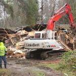<em>City of Poulsbo workers stand by as an excavator demolishes the vacant house at Centennial Park.</em><em> </em>Nick Twietmeyer/Kitsap News Group
