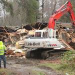 <em>City of Poulsbo workers stand by as an excavator demolishes the vacant house at Centennial Park.</em><em> </em>Nick Twietmeyer/Kitsap News Group