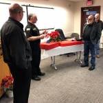 <em>At a well-attended reception in early January, retiring NKF&R Fire Commissioner Fernando Espy Espinosa, second from right, was honored with gifts presented by, from left, NKF&R Fire Chief Dan Smith, NKF&R Assistant Chief Rick LaGrandeur, and fellow commissioner Stephen Neupert.  </em>NKF&R photo