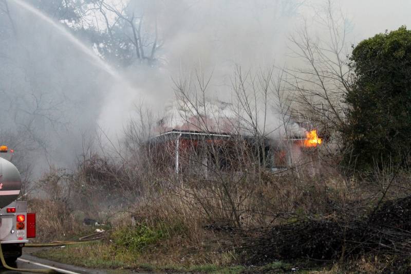 Bremerton city firefighters were working at 5 p.m. Feb. 3 to contain a house fire on Tracyton Beach Road. (Jacob Moore/Kitsap News Group)