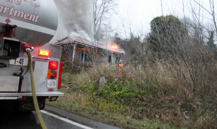 Bremerton city firefighters were working at 5 p.m. Feb. 3 to contain a house fire on Tracyton Beach Road. (Jacob Moore/Kitsap News Group)