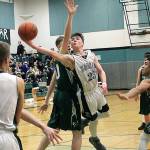 Klahowyas Gabriel Smith extends past the Vashon Island defense in his teams district game on Feb. 9. The Eagles season came to an end with a 52-42 loss. (Jacob Moore/Kitsap News Group)