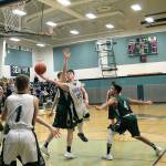 Klahowyas Gabriel Smith extends past the Vashon Island defense in his teams district game on Feb. 9. The Eagles season came to an end with a 52-42 loss. (Jacob Moore/Kitsap News Group)