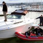 John Davis, Robert Fortney and Aaron Wenholz work to jockey a 27-foot motor yacht at the Port of Poulsbo boat launch. The boat sank on Feb. 4, spilling an unknown quantity of fuel into the bay. Nick Twietmeyer | Kitsap News Group