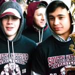 Xavier Eaglin (left) and Dylon Murray carry the state high school 4A wrestling championship trophy down the sidewalk. (Mark Krulish | Kitsap Daily News)
