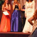 Senior contestants Christina Bohem (far left), Hannah Haynes and Cory Miller (partially hidden) applaud as Tamara Medal reacts emotionally as she learns of her selection as 2018 Fathoms O Fun Royalty Court Queen March 3. (Bob Smith | Kitsap Daily News)