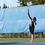 Junior Sydney Troy, right, watches as senior Brooklyn Haro serves the ball in a March 6 practice at the Olympic High School tennis courts. Haro and Troy went to state last year as a doubles team. Jacob Moore | Kitsap News Group