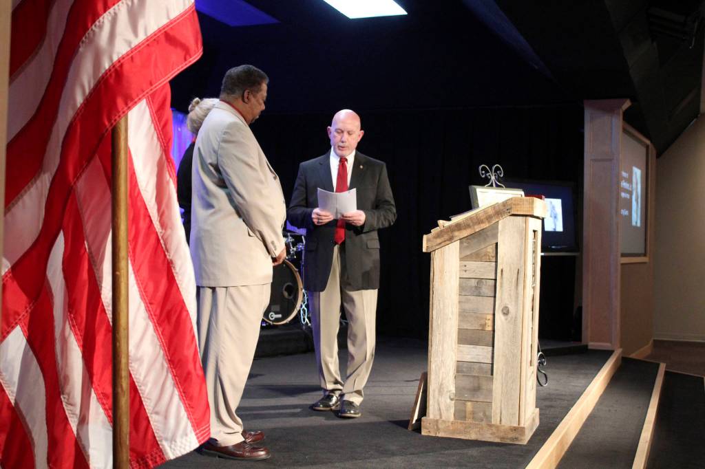 Retired Air Force Col. Steven Wexler presents Robert and Carolynn Perkins with a replica of the Congressional Gold Medal, awarded to Robert Perkins father posthumously.                                Michelle Beahm | Kitsap News Group