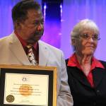 <em>Robert and Carolynn Perkins accept a replica of the Congressional Gold Medal on behalf of Roberts father, Roscoe Perkins.</em>                                Michelle Beahm/Kitsap News Group