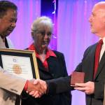 <em>Robert and Carolynn Perkins accept a replica of the Congressional Gold Medal on behalf of Roberts father, Roscoe Perkins.</em>                                Michelle Beahm/Kitsap News Group