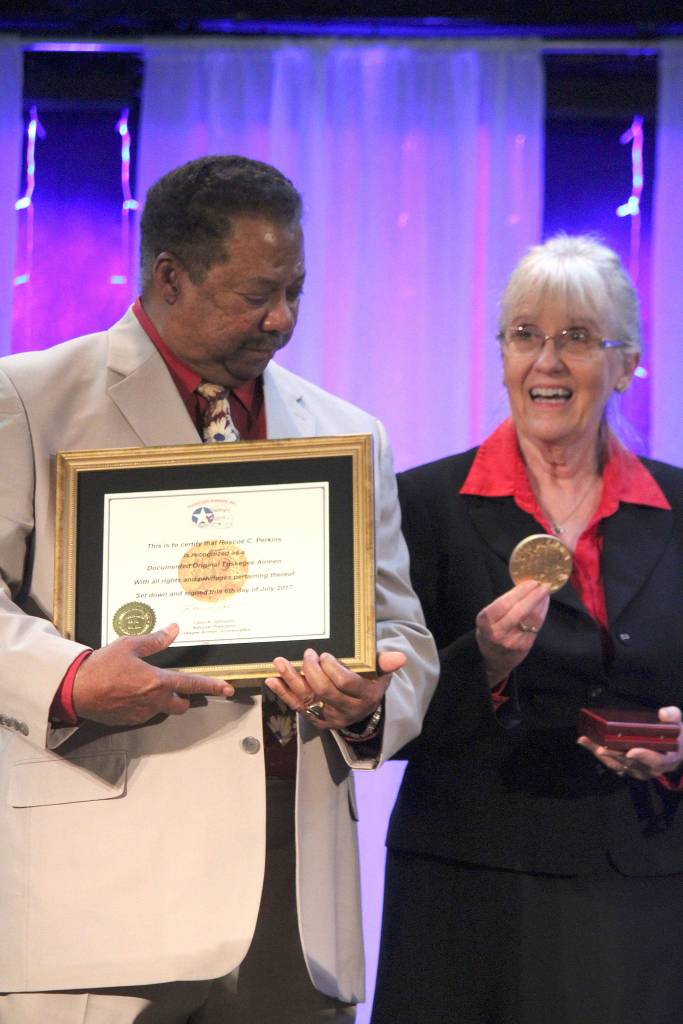 <em>Robert and Carolynn Perkins accept a replica of the Congressional Gold Medal on behalf of Roberts father, Roscoe Perkins.</em>                                Michelle Beahm/Kitsap News Group