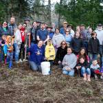 Gleaning volunteers gather for a group photo at the end of their harvesting work at Rokalu Farm in South Kitsap on March 18. (Bob Smith | Kitsap Daily News)
