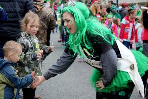 A local pageant queen greets children in the crowd of spectators at the St. Patricks Day Parade in downtown Bremerton March 17.                                Michelle Beahm | Kitsap News Group