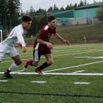 Kingston junior defender Davey Anderson, right, and Klahowya senior forward Darius Joe battle for the ball during the first half of their March 19 game. The Buccaneers won 2-1. Jacob Moore | Kitsap News Group
