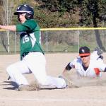 Cougars sophomore third baseman Kade Coombe dove, but missed the tag on Peninsula sophomore outfielder Peter King. Jacob Moore | Kitsap News Group