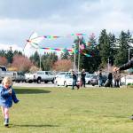 Helena Ptaszynski, 2, runs to get her kite airborne while mother, Beth, coaches nearby. Nick Twietmeyer | Kitsap News Group