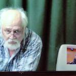 Clinton R. Caldwell, 67, of Sequim appears on a television monitor with an inset of Clallam County Superior Court Judge Chris Melly during Caldwells first court appearance Tuesday in connection with his arrest in a Net Nanny operation. (Keith Thorpe/Peninsula Daily News)