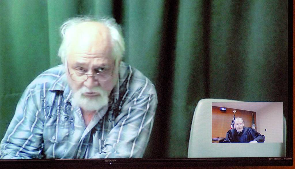 Clinton R. Caldwell, 67, of Sequim appears on a television monitor with an inset of Clallam County Superior Court Judge Chris Melly during Caldwells first court appearance Tuesday in connection with his arrest in a Net Nanny operation. (Keith Thorpe/Peninsula Daily News)