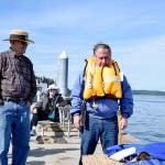 <em>A member of the Bremerton Sail and Power Squadron demonstrates inflating a life jacket.</em>                                Rick Hurst / Bremerton Sail and Power Squadron