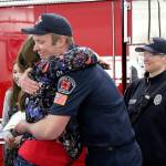 Jennifer Gutierrez hugs firefighter Elliott Bresnan, who was part of the crew that responded to the 911 call to save Gutierrez life.                                Michelle Beahm / Kitsap News Group