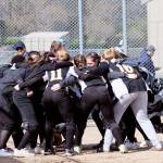 South Kitsap athletes and coaches in a huddle near home plate before the match against Bellarmine Prep. Jacob Moore | Kitsap Daily News