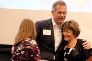 <em>Monica Blackwood, Steve Politakis and Patty Lent hug at the Kitsap Economic Development Alliance meeting March 30 after Blackwood and Politakis granted Lent a lifetime achievement award.</em> Michelle Beahm / Kitsap News Group