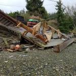 Two shorefront decks were destroyed when a vehicle driven by a 15-year-old, lost control and crashed into Liberty Bay. Photo courtesy Luis Barrantes.