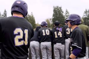 Kyle Green and Isaac Richardson enter the dugout while receiving the silent treatment, a baseball custom for a first home run, after Greens three-run homer. Jacob Moore | Kitsap Daily News
