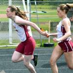South Kitsaps Danae Hughes takes the handoff from Ashley Twiss during the sprint medley relay. (Mark Krulish/Kitsap News Group)