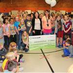 Olalla Elementary physical education teacher Sara Gray, in the center of the photo holding balloons, receives a surprise visit by a CenturyLink representative April 23, who presented her with a nearly $5,000 grant through the telecommunications companys Teachers and Technology program. (South Kitsap School District photo)