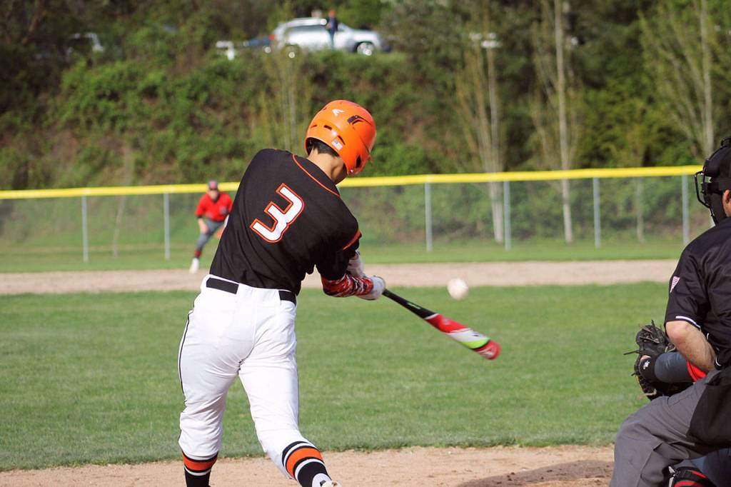 Cougars senior Rylee Orteza goes the other way on an outside pitch. Jacob Moore | Kitsap Daily News