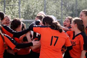 Central Kitsaps dugout empties around home plate to celebrate Faith Schenks home run in the bottom of the fifth inning. Jacob Moore | Kitsap Daily News
