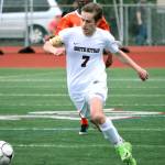 Senior forward Grant Larson dribbles down the field. Larson scored the first goal of the game in the seventh minute. (Mark Krulish/Kitsap News Group)