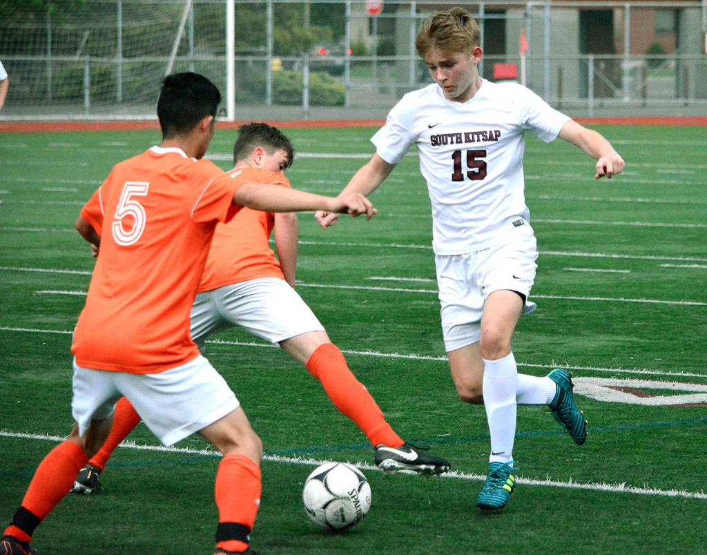 South Kitsap junior Brian Yand tries to get by two Decatur defenders in the district playoff game. (Mark Krulish/Kitsap News Group)