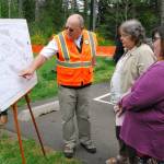 Jay Rosapepe, a Port Orchard city councilman, points out recreational elements of the Phase II project to two residents at the groundbreaking ceremony.                                Bob Smith | Independent